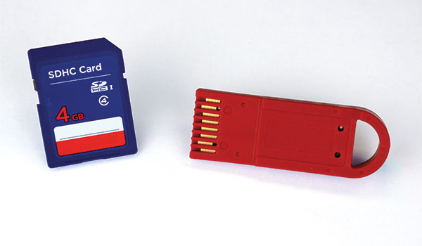 SD card (left) next to a Datakey DFX RUGGEDrive memory token (right).