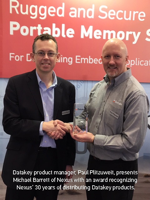 Datakey product manager, Paul Plitzuweit, presents Michael Barrett of Nexus with an award recognizing Nexus' 30 years of distributing Datakey products.